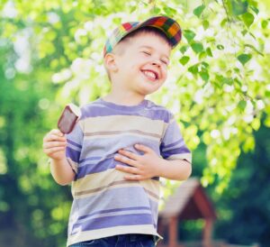 Contented small boy eating an ice cream