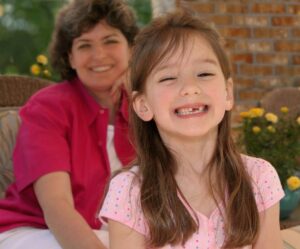 Little girl smiling with mother at Kidtastic Dental in Gilbert